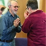 Image of Namaste greeting between two men. The "Namaste" greeting we share during services reflects the spirit with which we work and play together -- honoring and recognizing the Divinity in each one.