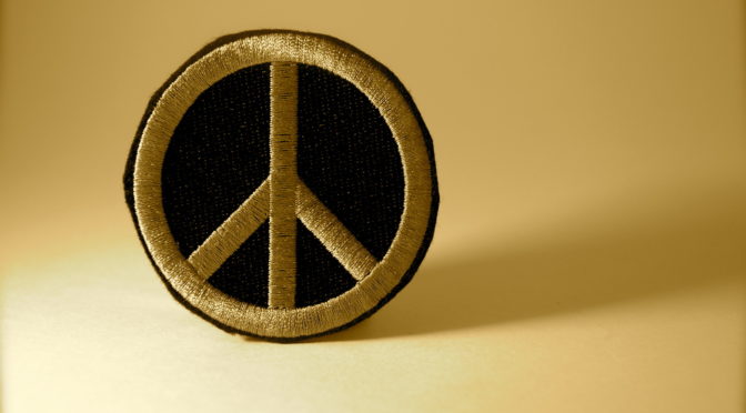 Peace patch on golden background.
